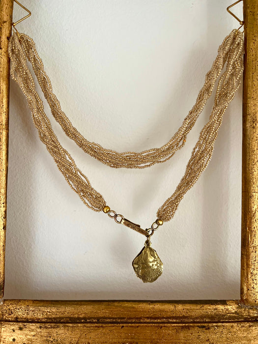 Murano glass-beads necklace with a handmade brass seashell pendant.